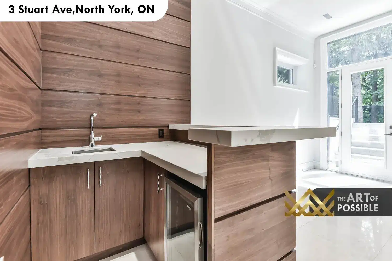 Lower level wet bar with walnut cabinetry, white quartz countertop, undermount sink and beverage fridge