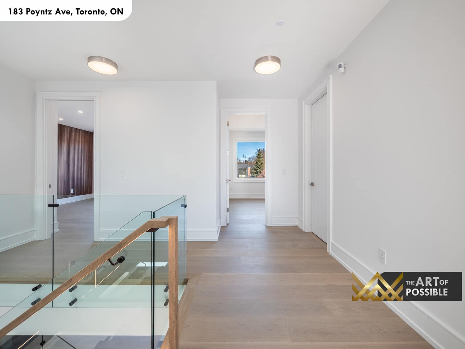 183 Poyntz Ave North York upper hallway with glass panel railing oak handrail and flush-mount drum lighting