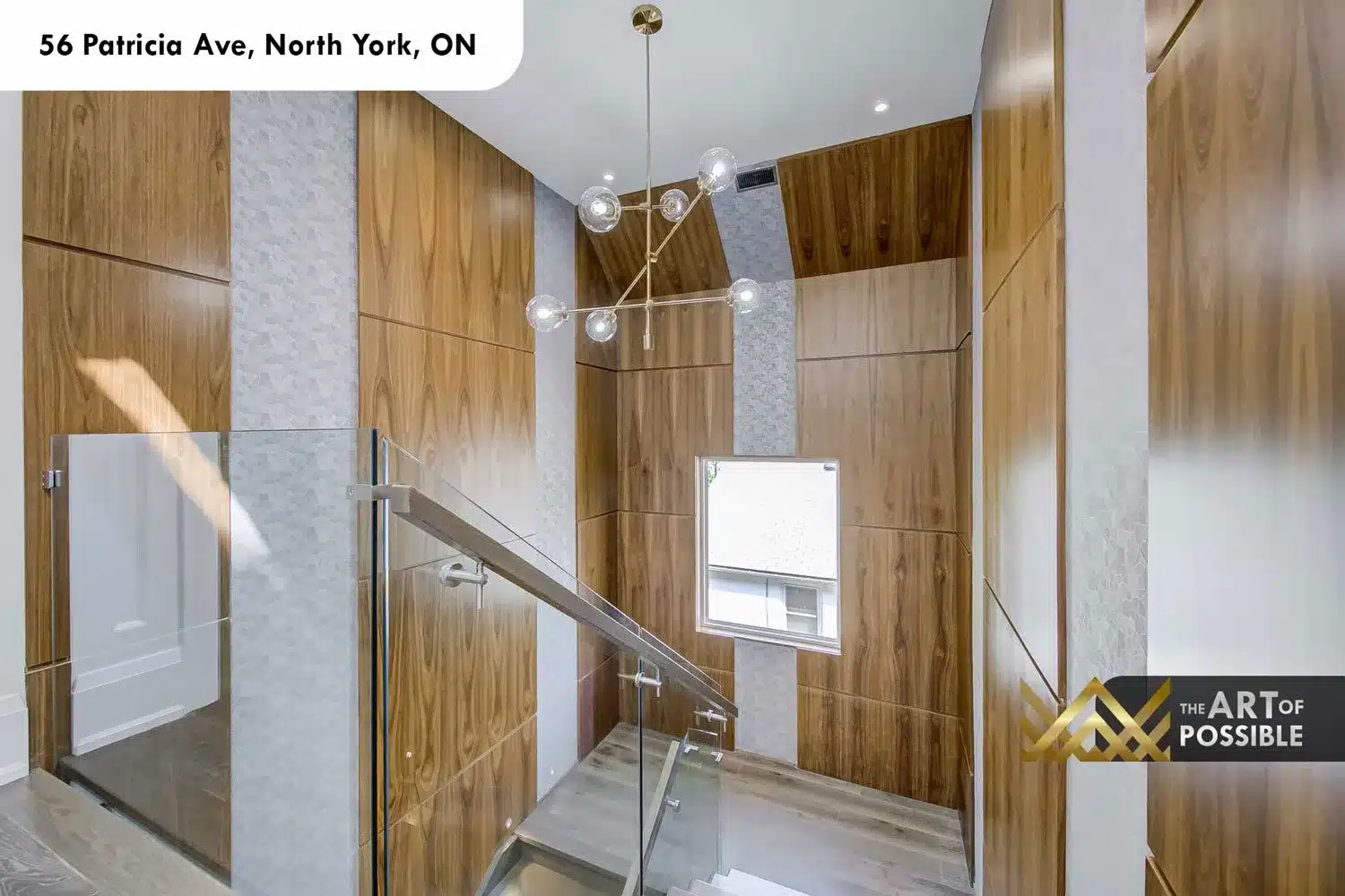 Upper staircase landing with walnut panels and globe chandelier at 56 Patricia Ave