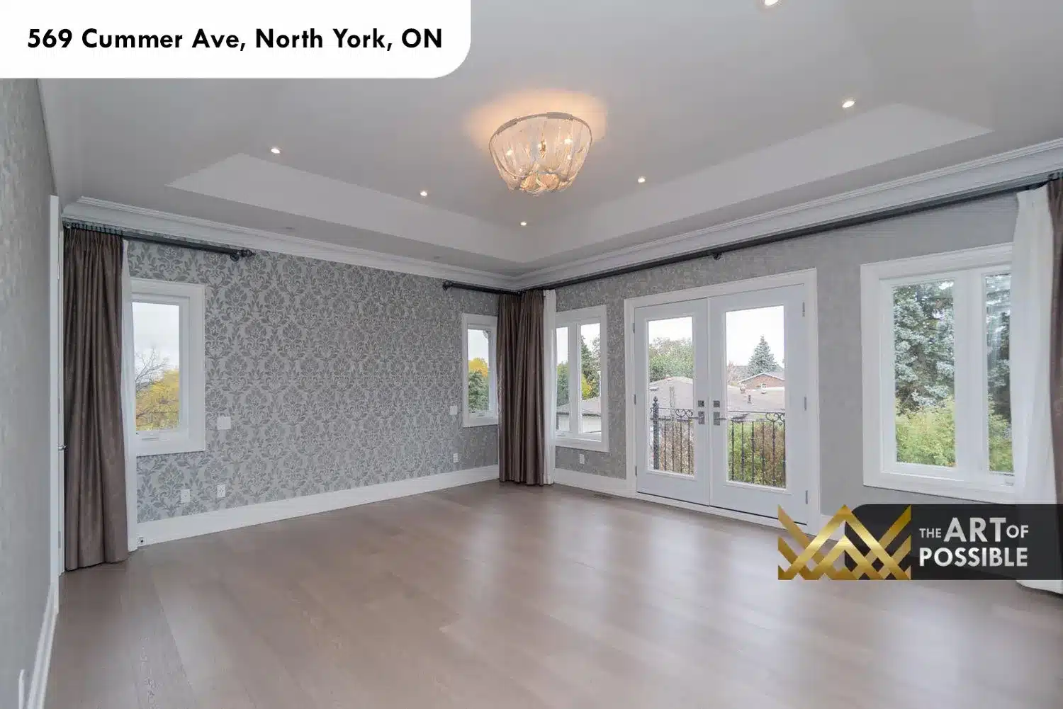 569 Cummer Ave primary bedroom grey damask wallpaper tray ceiling French doors Juliet balcony wrought iron