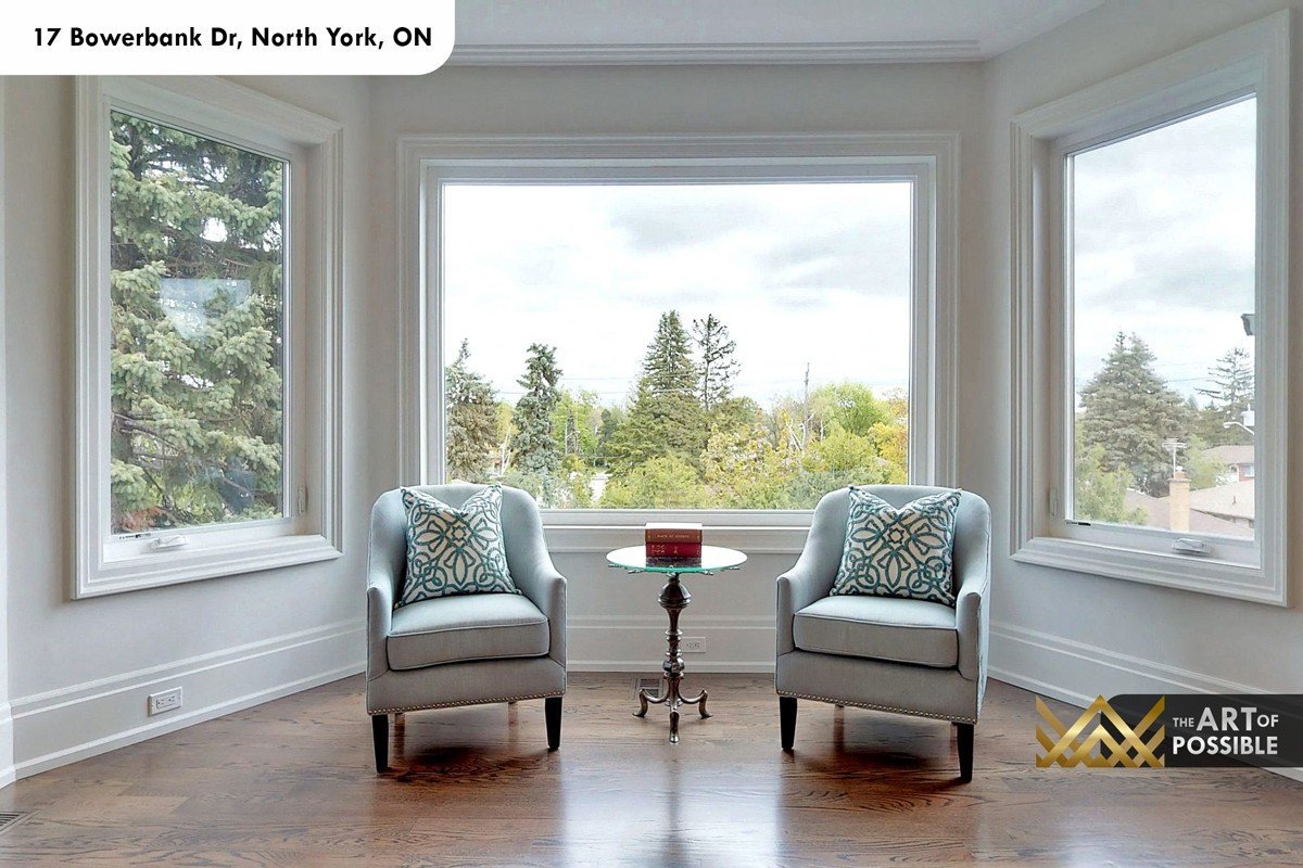 Primary bedroom bay window sitting area with treetop views