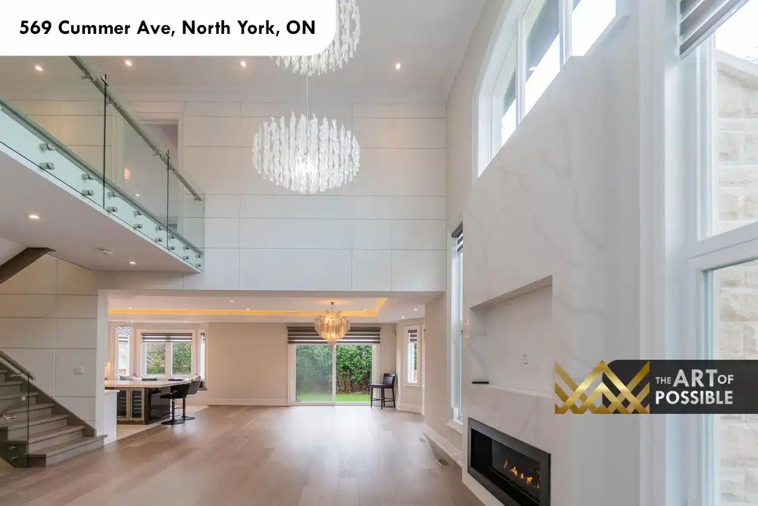 569 Cummer Ave living room double height ceiling capiz chandeliers marble fireplace glass railings above