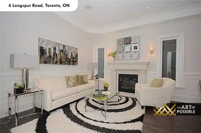 Formal sitting room with wainscoting, white fireplace and wall sconces at 6 Longspur Road Toronto