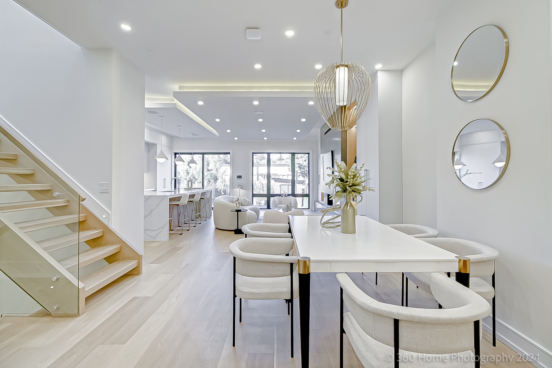 Dining area at 100 Glenvale Blvd with gold woven pendant chandelier and stacked circular mirrors