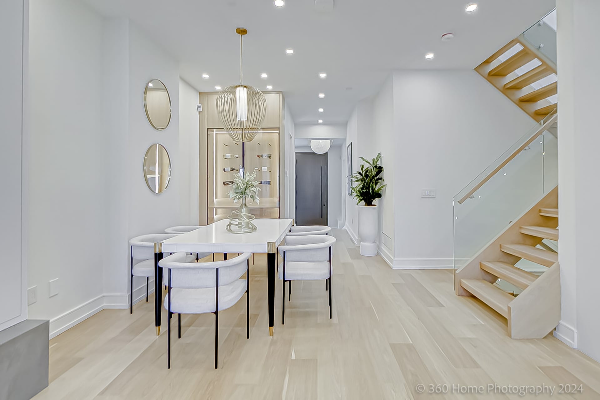 Dining room view toward illuminated display cabinet at 100 Glenvale Blvd