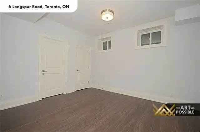 Lower level bedroom with dark hardwood floors and recessed lighting at 6 Longspur Rd Toronto