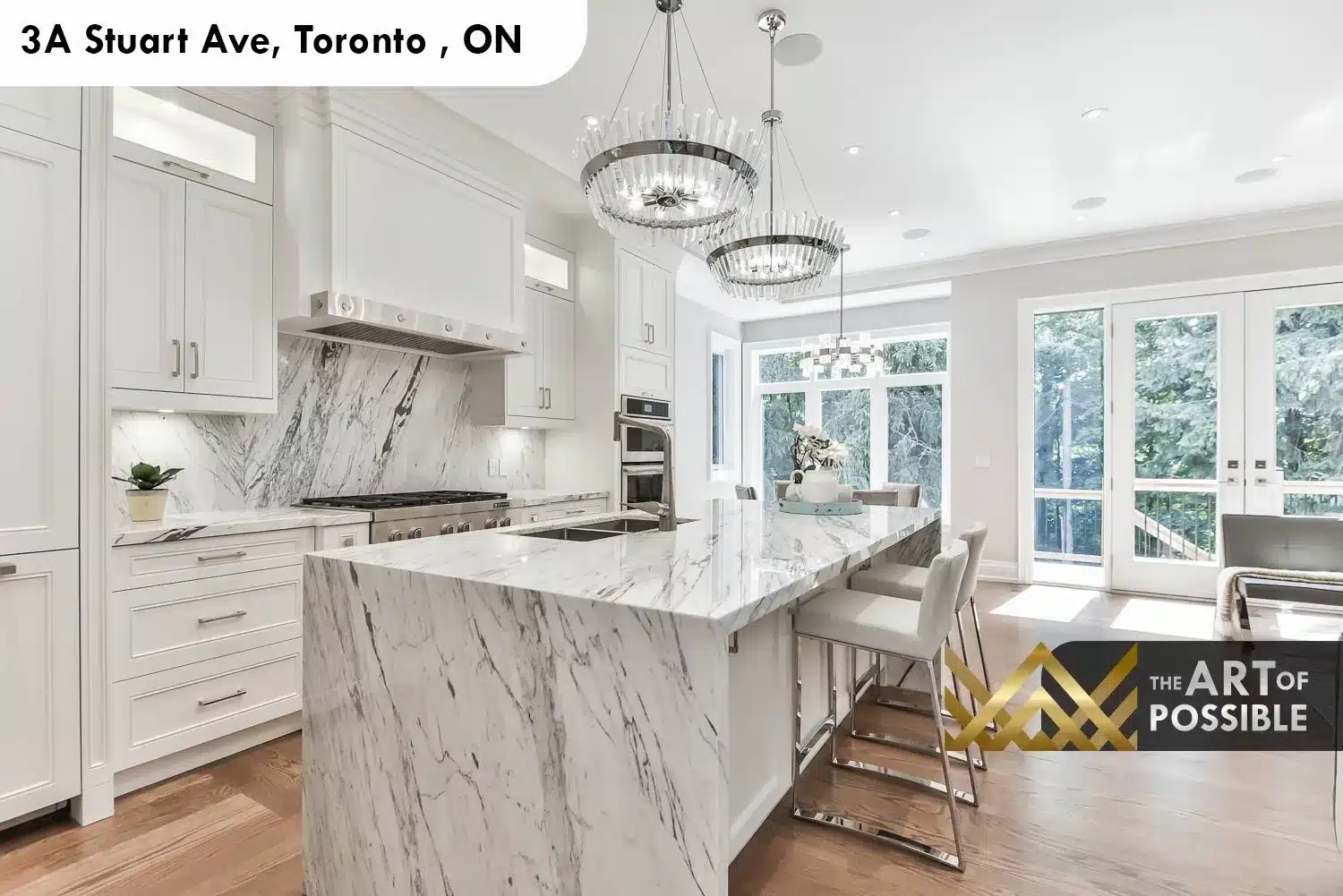 Marble waterfall island with chrome bar stools and crystal drum chandeliers in 3A Stuart Ave kitchen