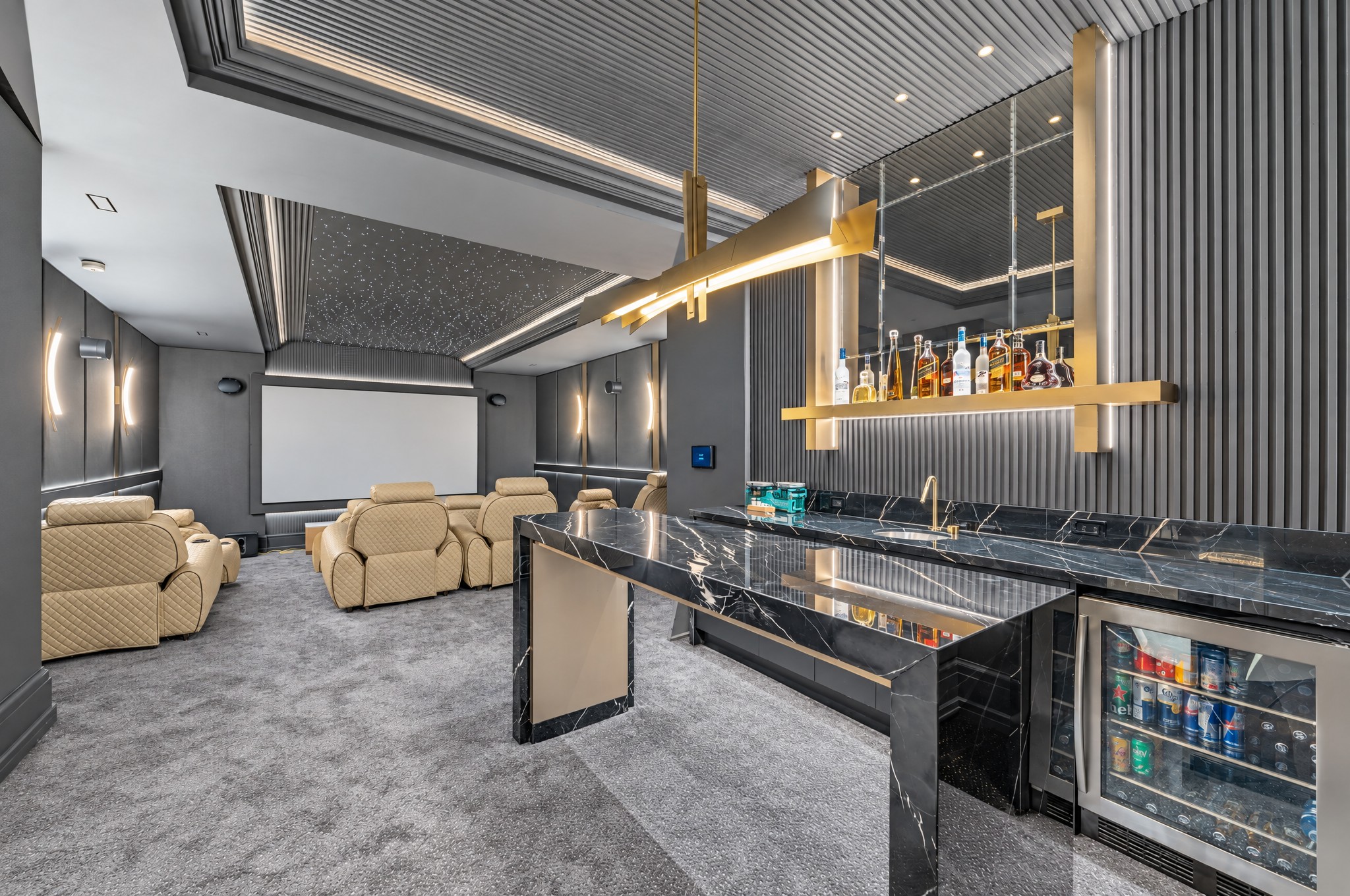 Home theatre with quilted leather recliners, star ceiling and black marble bar