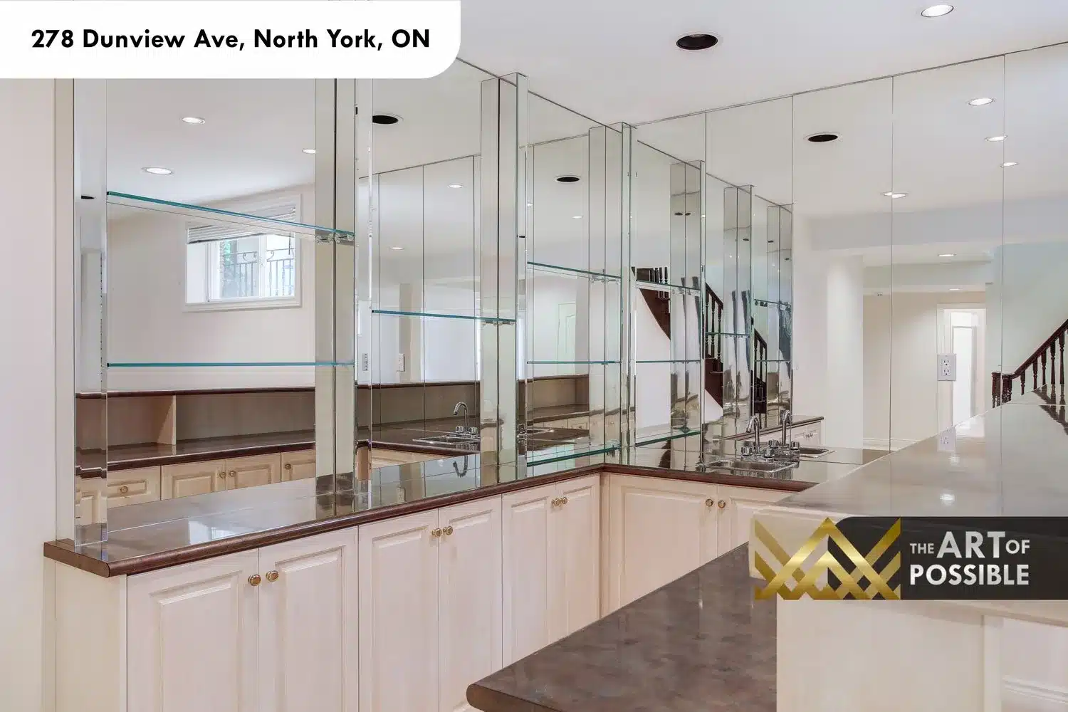 Basement wet bar with floor-to-ceiling mirrored wall and glass display shelves