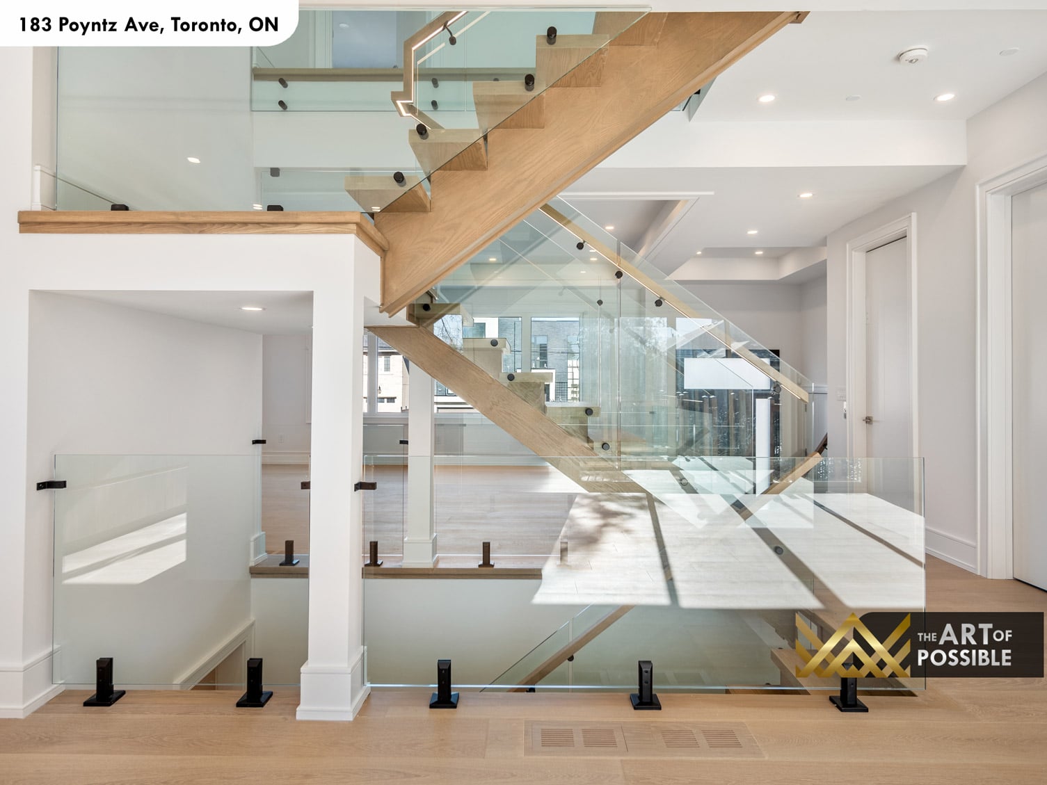 183 Poyntz Ave North York floating open-tread oak staircase detail with glass railings across three storeys