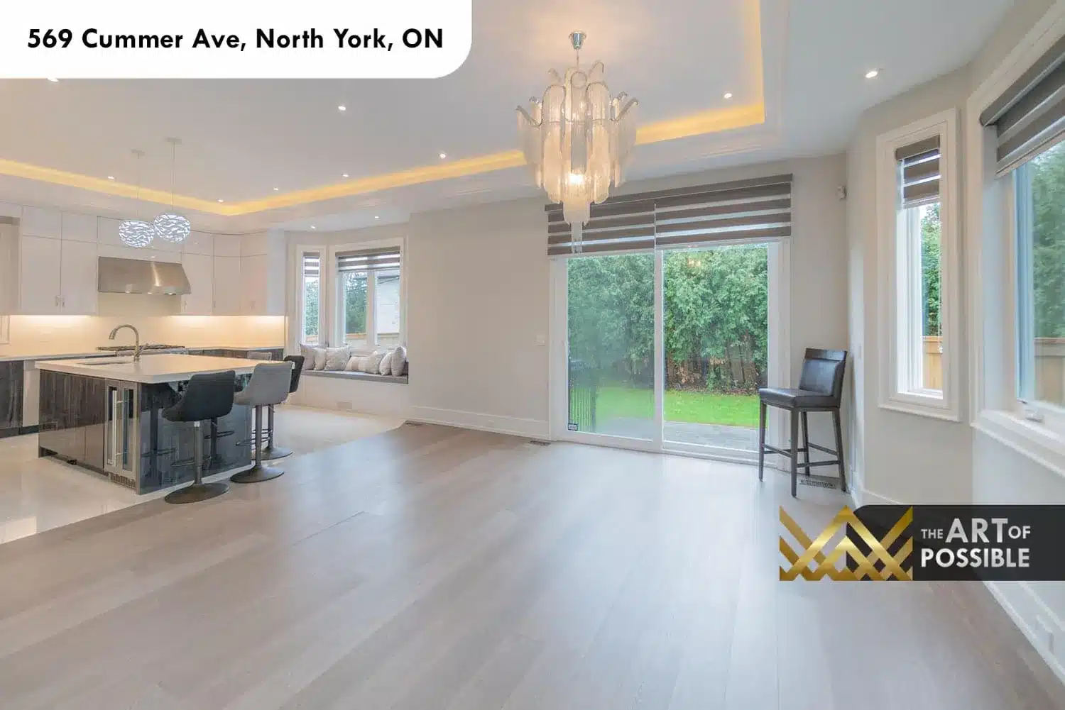 569 Cummer Ave dining area tray ceiling LED cove lighting glass chandelier kitchen island view