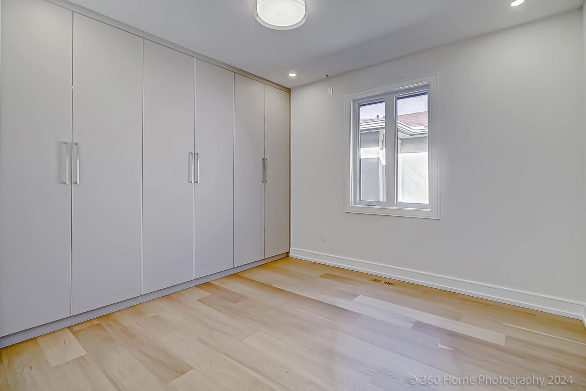 Secondary bedroom with full-height white built-in wardrobe at 100 Glenvale Blvd