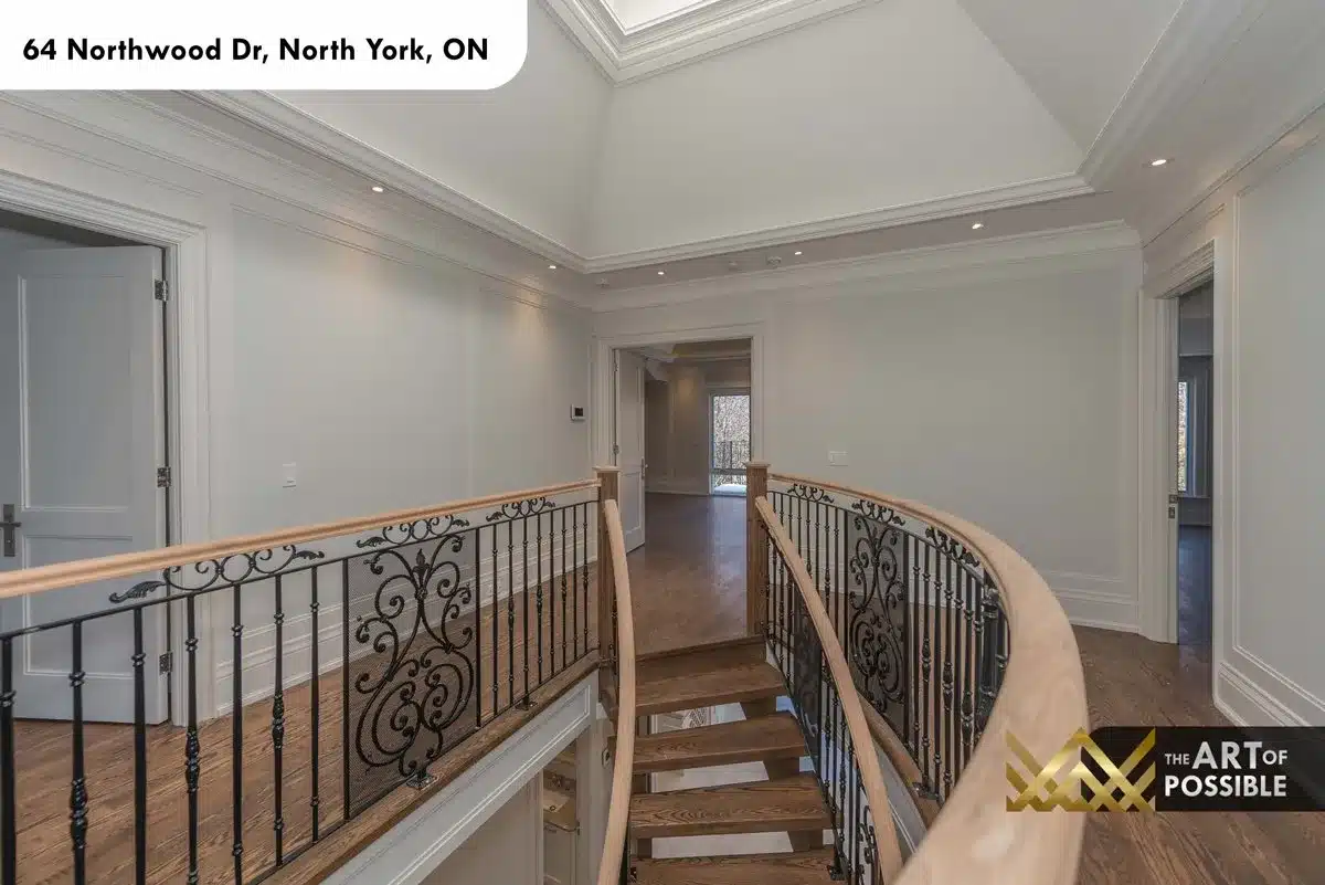 Second floor hallway with tray ceiling and curved iron railing