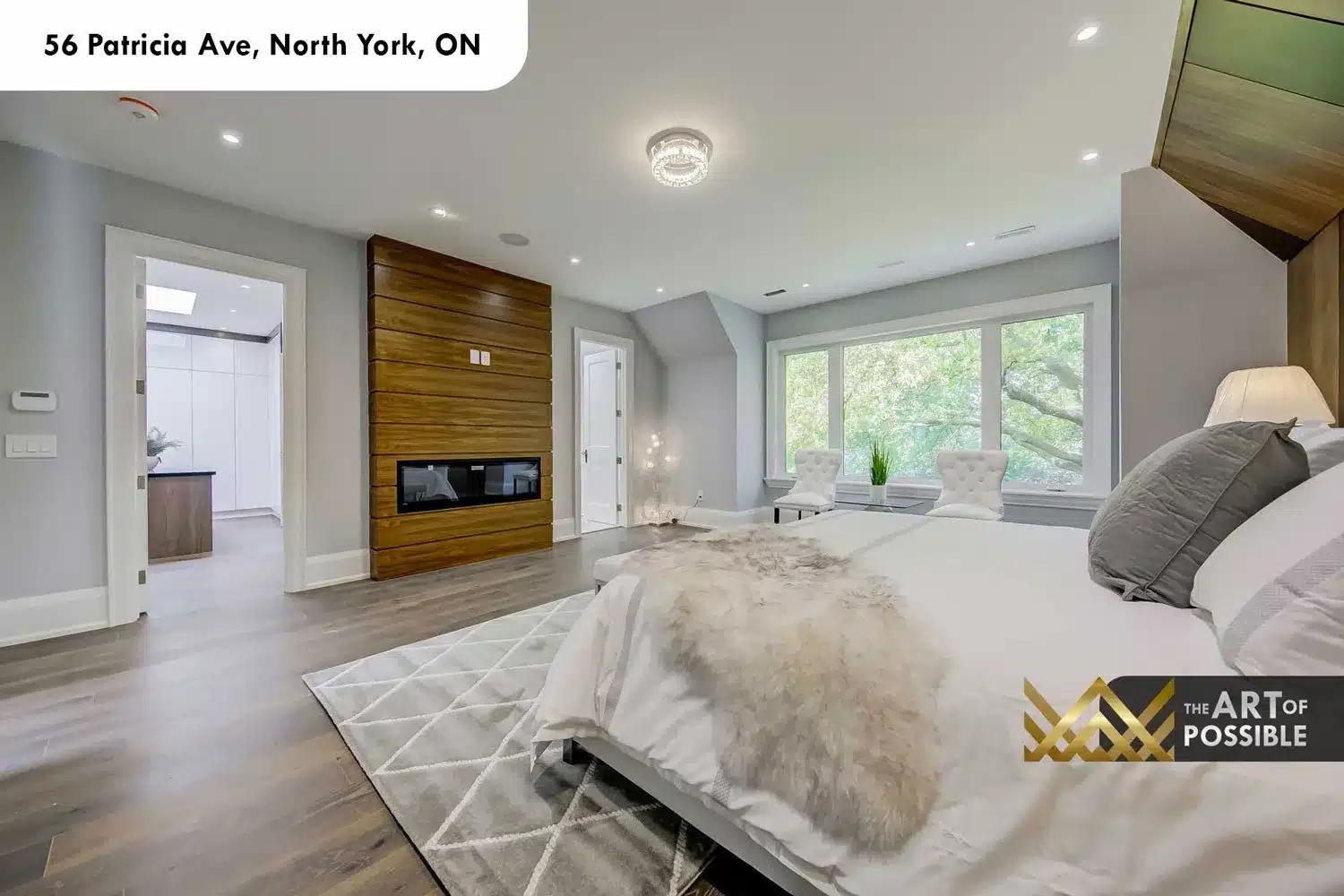 Primary bedroom showing linear fireplace in walnut surround at 56 Patricia Ave