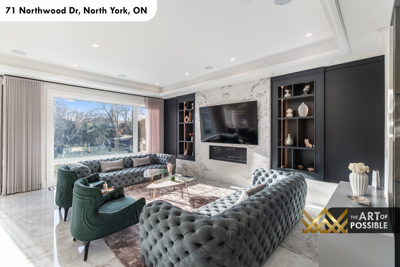 Family room with full-height Calacatta marble TV wall and dark charcoal flanking built-ins