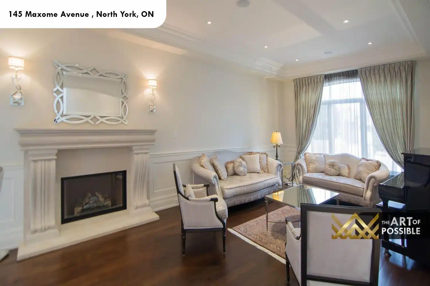 145 Maxome Avenue living room limestone fireplace coffered ceiling crystal sconces Venetian mirror