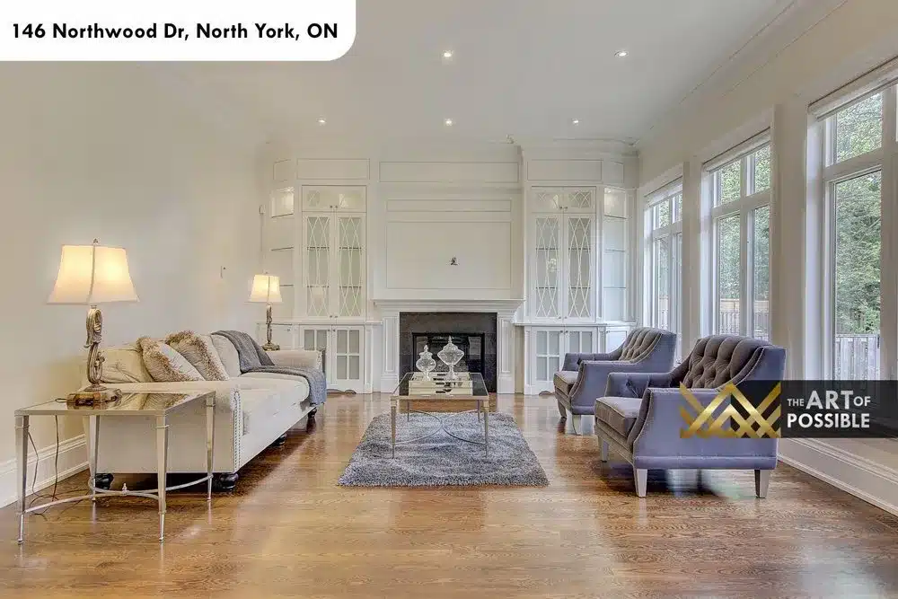 Great room with marble fireplace and white glass-front built-in cabinets
