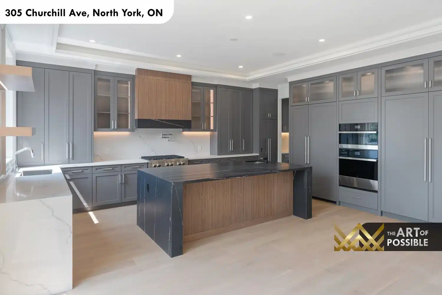 Kitchen with reeded walnut island sides, dark marble waterfall countertop and marble backsplash slab