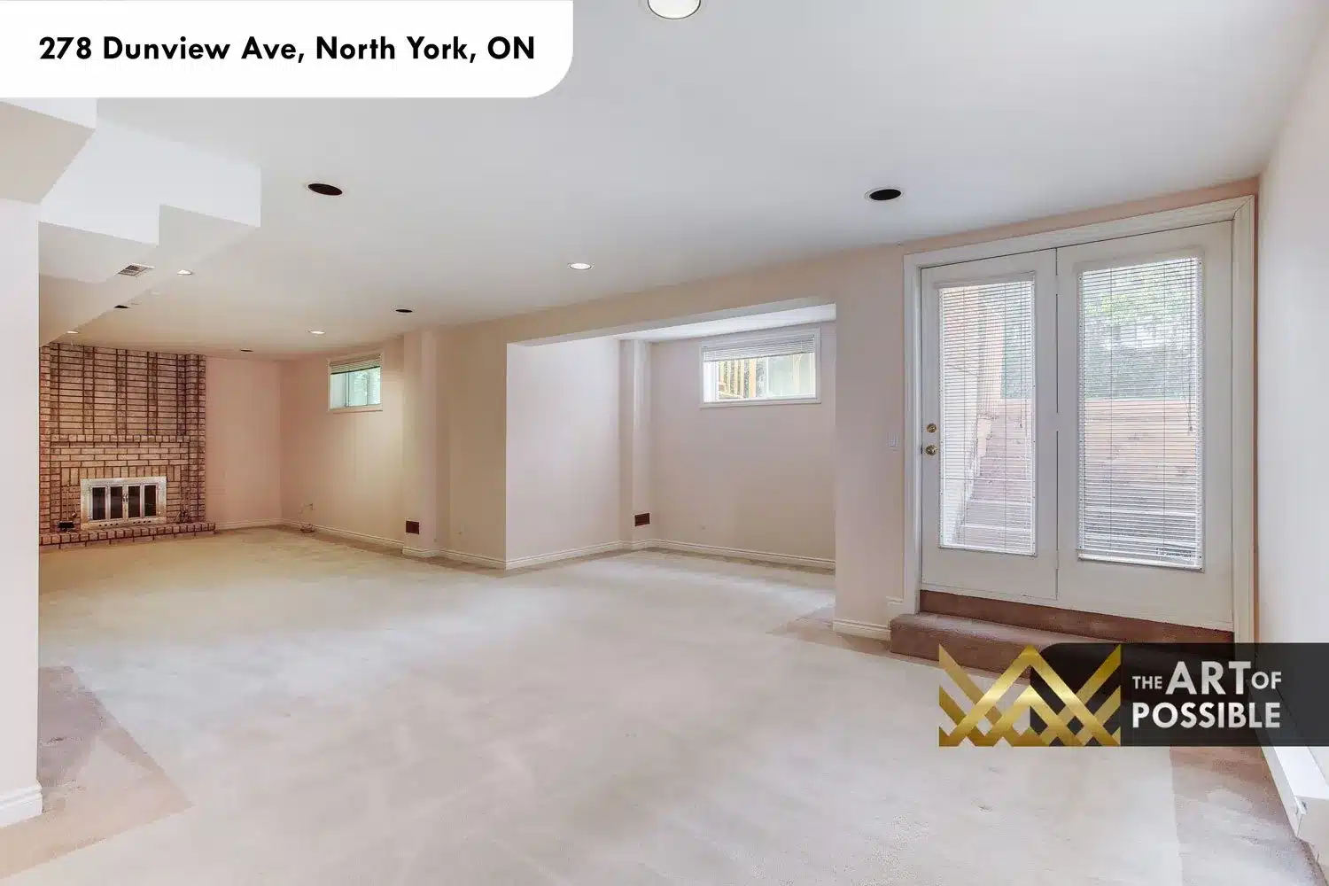 Lower level walkout to yard with brick fireplace and open recreation space