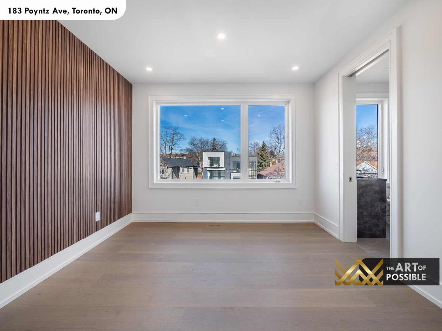 183 Poyntz Ave North York upper floor bedroom with walnut slatted wall and picture window with en suite doorway