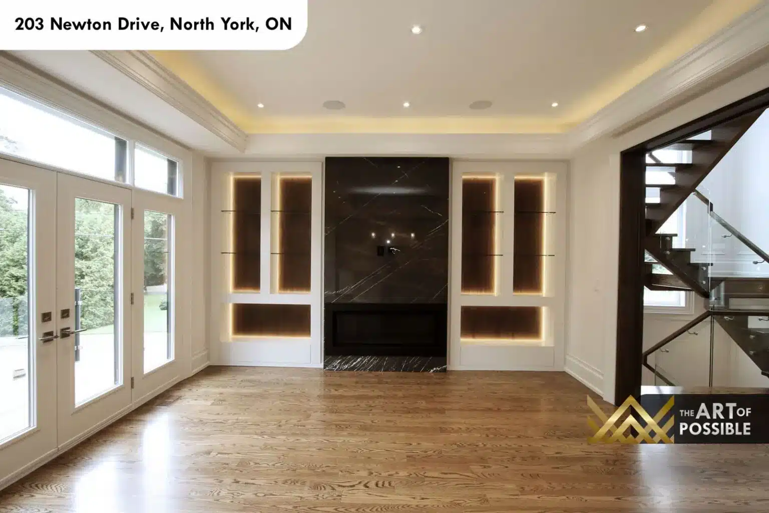 Family room with black marble fireplace wall and LED-lit display niches