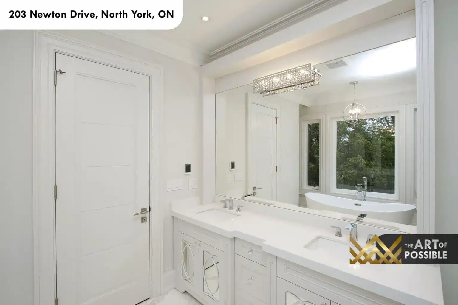 Walk-in dressing room with fitted white cabinetry and mirrored doors