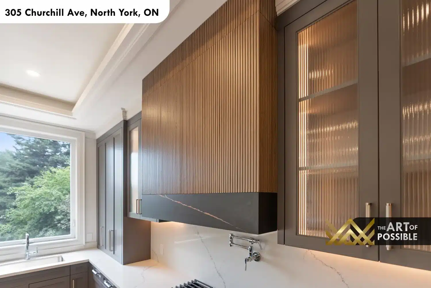 Kitchen range zone with walnut slat hood, dark marble fascia, pot filler and marble backsplash