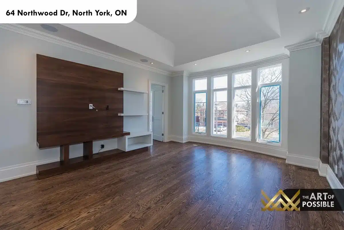 Secondary bedroom with walnut media wall and large windows