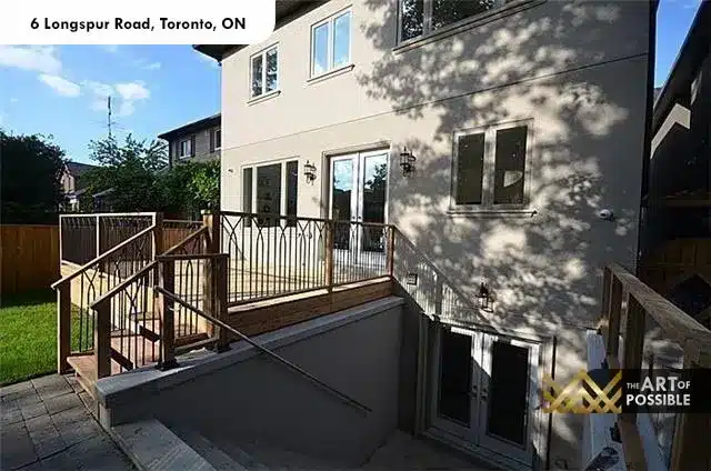 Rear deck with iron railing and walkout to backyard at 6 Longspur Rd Toronto