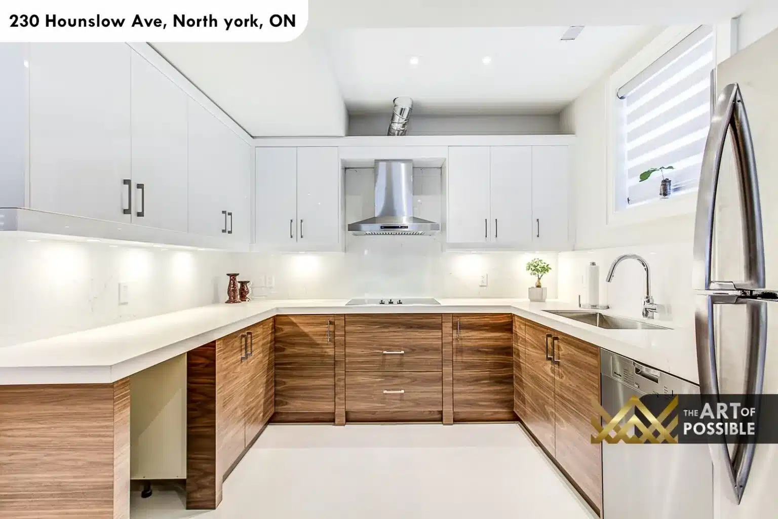 Second kitchen in lower level with walnut cabinetry and white quartz counters