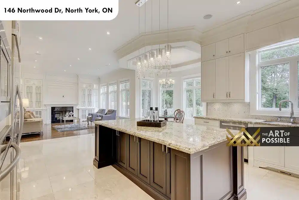Breakfast bay with round table and tray ceiling beside the kitchen