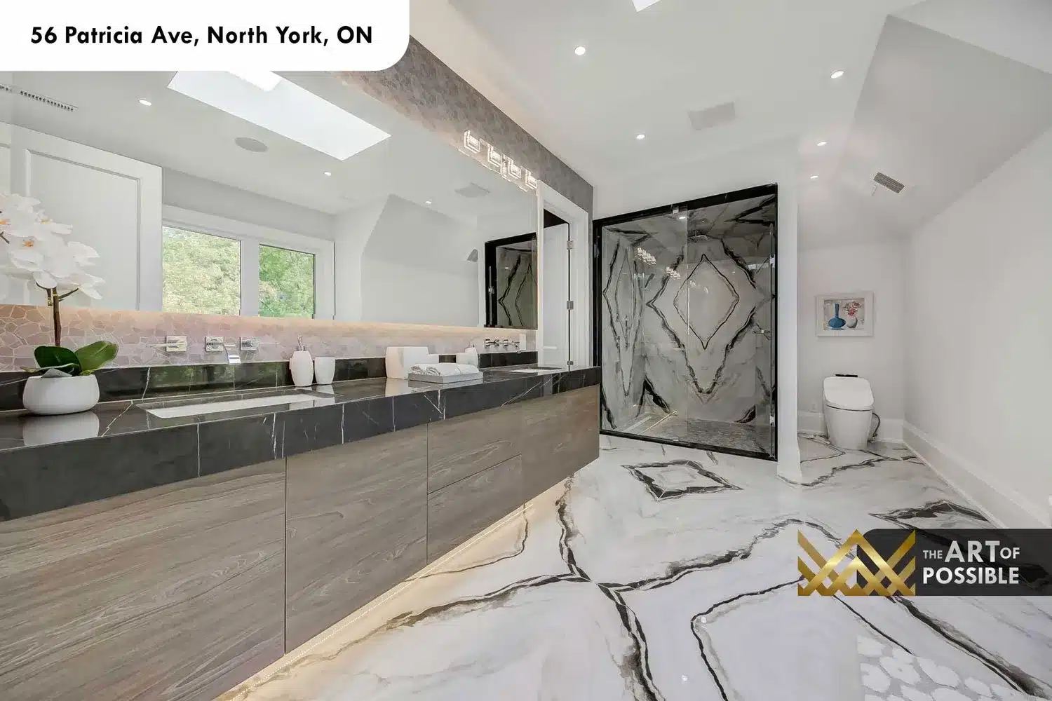 Primary ensuite at 56 Patricia Ave with marble floor, skylight and walk-in glass shower