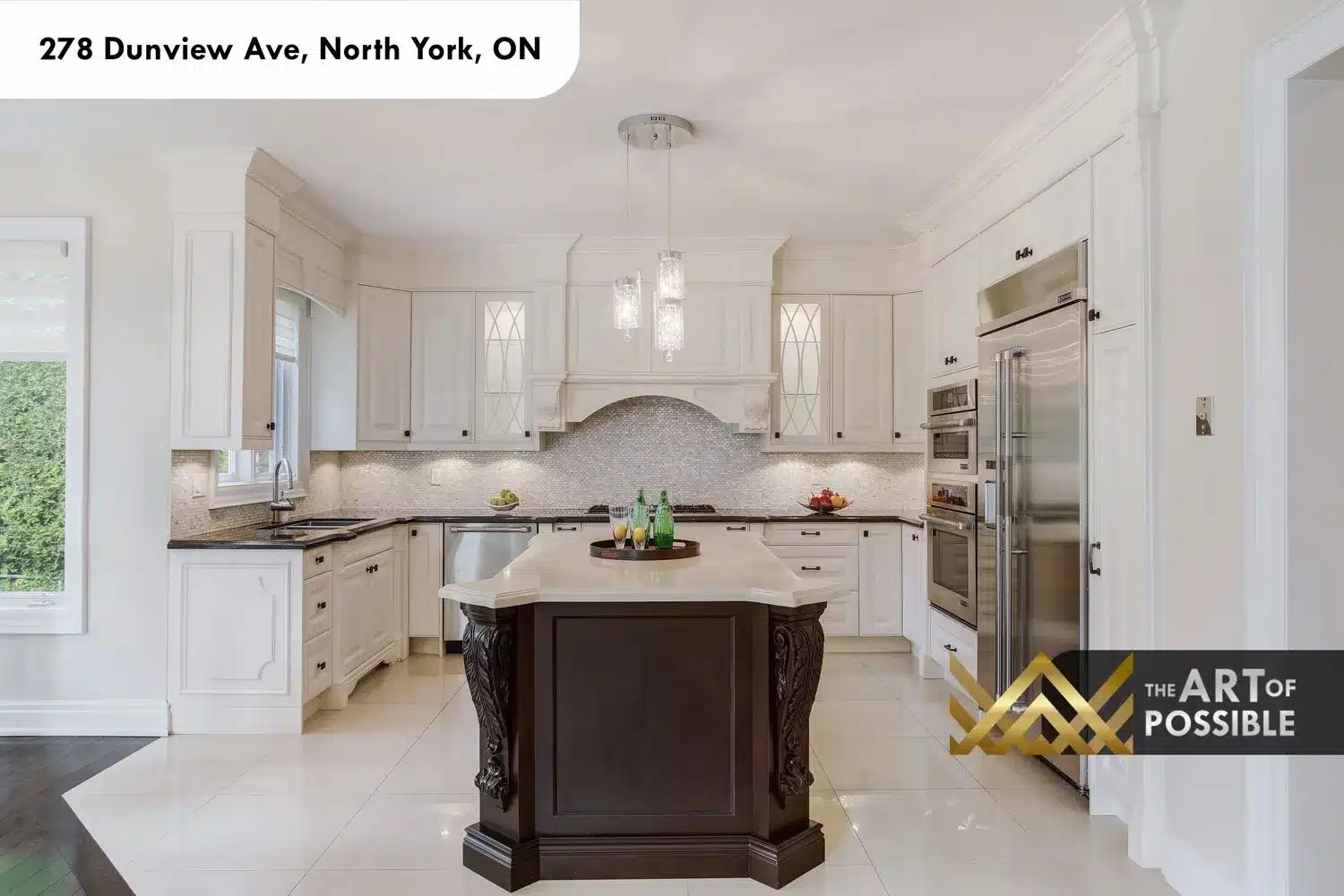 Kitchen at 278 Dunview Ave, white cabinetry, carved hood, dark island with acanthus-leaf legs, mosaic tile backsplash