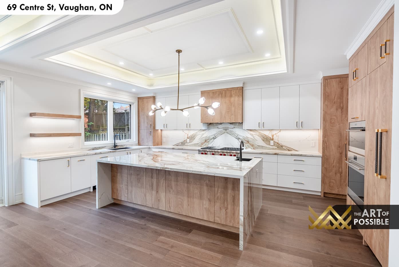 Kitchen with Calacatta marble backsplash, walnut upper cabinets and waterfall island