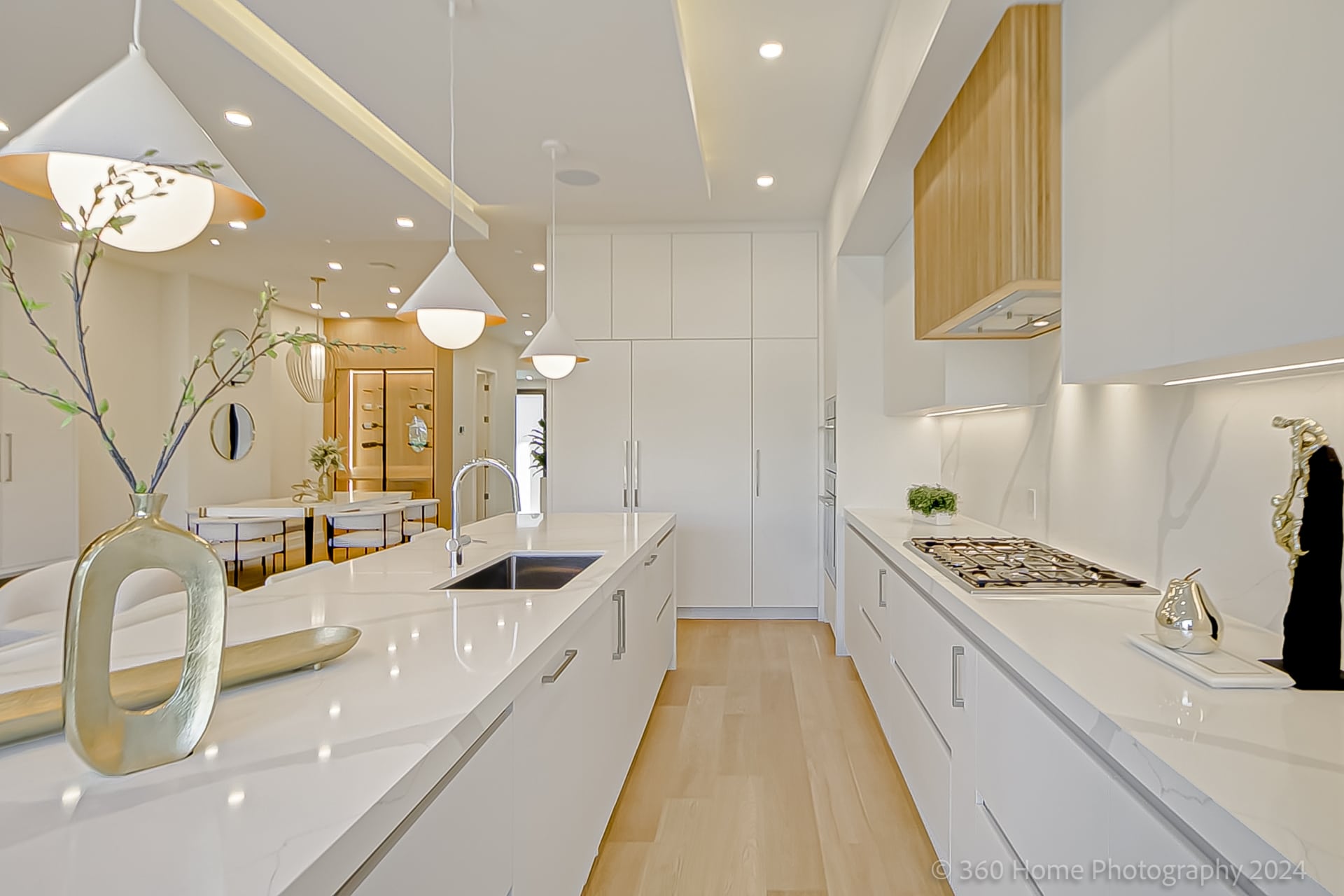 Kitchen island with cone pendant lights and view toward dining area at 100 Glenvale Blvd