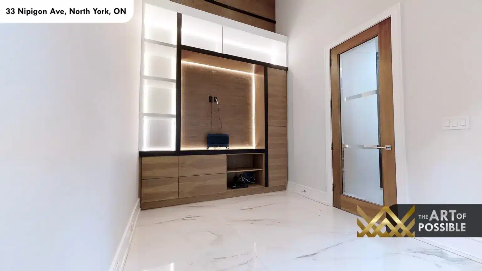 Lower level media room with built-in walnut TV unit and frosted glass door