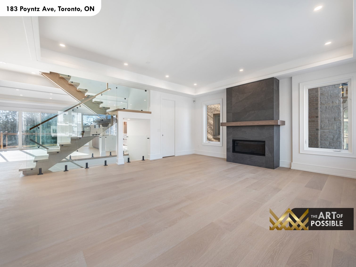 183 Poyntz Ave North York open-tread oak staircase with full-height glass panel railings and black steel fittings