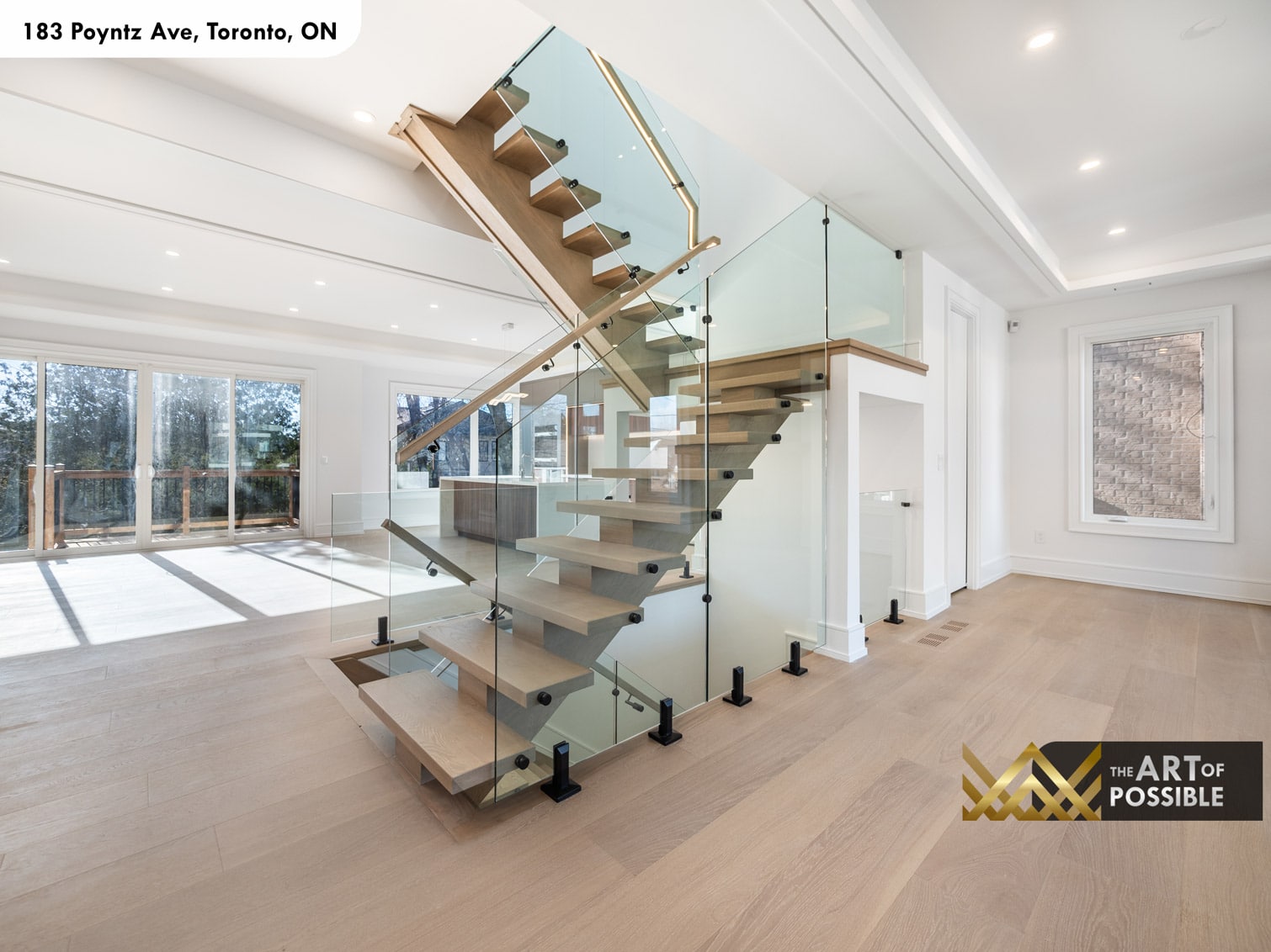 183 Poyntz Ave North York staircase with open oak treads glass panels and view to rear sliding glass door
