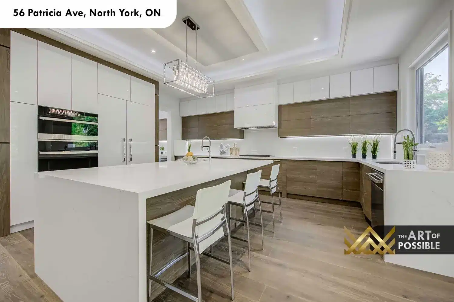 Kitchen island with seating and crystal pendant at 56 Patricia Ave