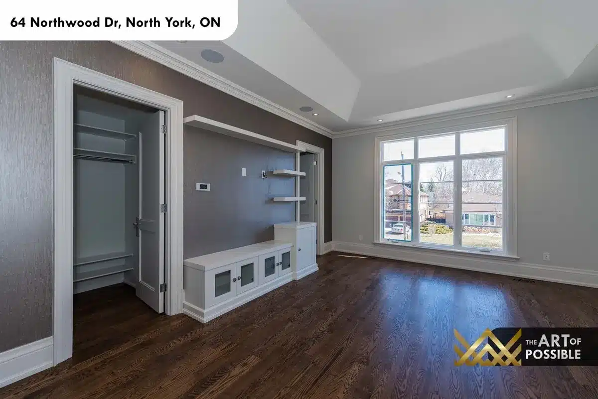 Secondary bedroom with built-in shelving and tray ceiling