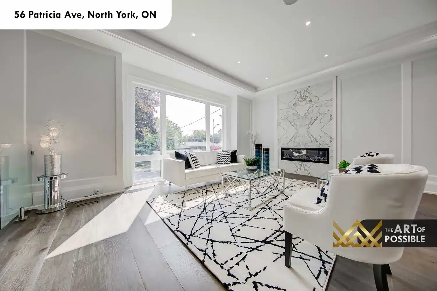Living room at 56 Patricia Ave with book-matched marble fireplace and tray ceiling