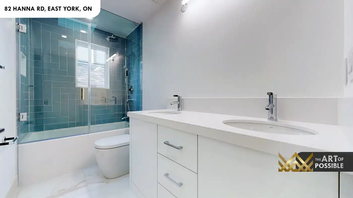 Secondary bathroom with teal stacked tile tub surround and double vanity at 82 Hanna Rd