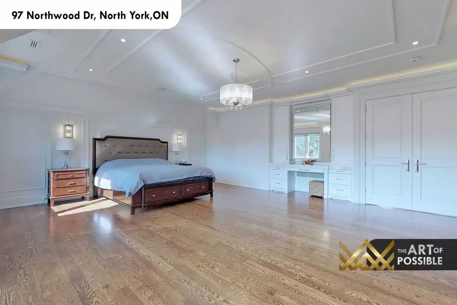 97 Northwood Dr primary bedroom built-in dressing vanity vaulted ceiling wall sconces