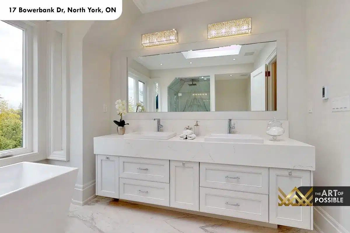 Primary ensuite double floating vanity with white marble countertop, vessel sinks and crystal bar sconces