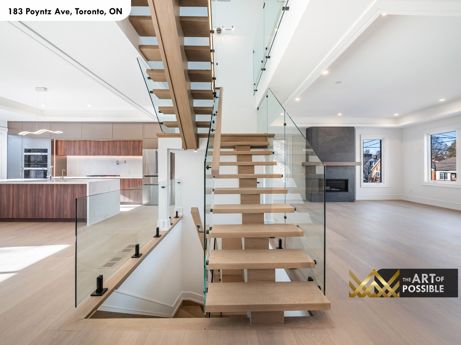 183 Poyntz Ave North York staircase rising from main floor showing kitchen and living room in the background