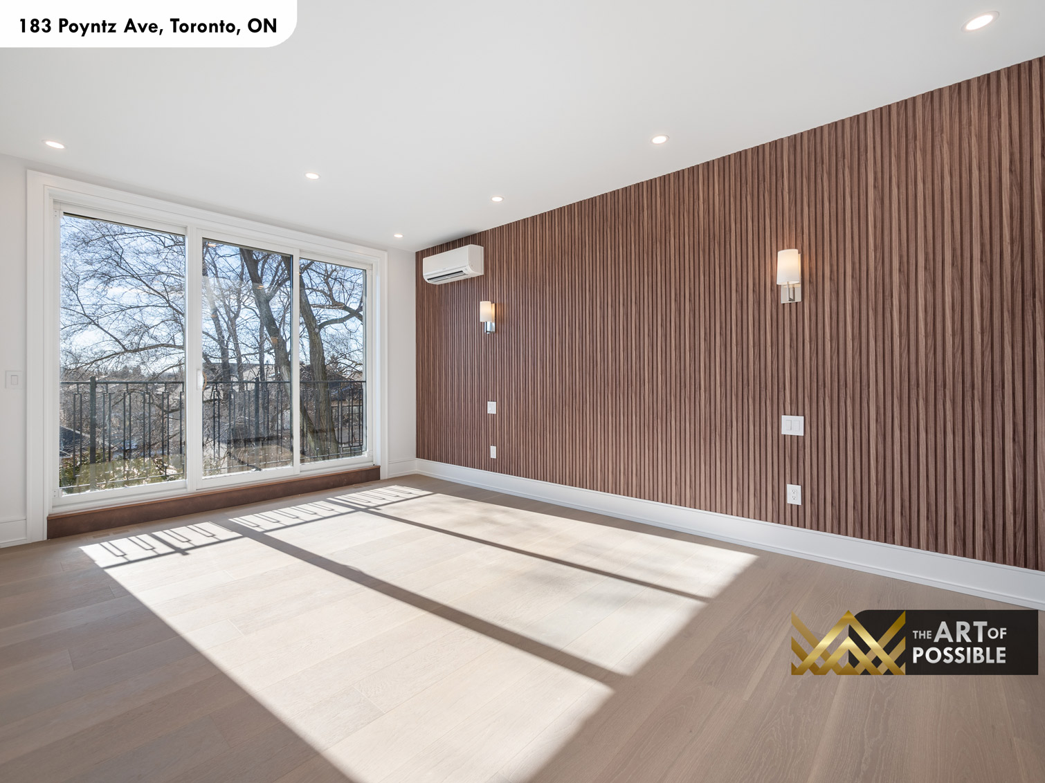 183 Poyntz Ave North York primary bedroom with walnut slatted accent wall wall sconces and sliding glass door to terrace
