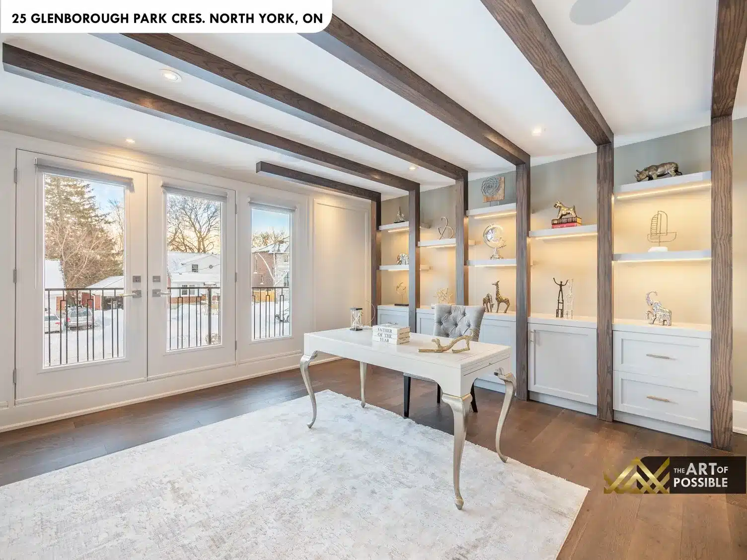 Family room floor-to-ceiling bookmatched dark stone fireplace wall and white built-ins