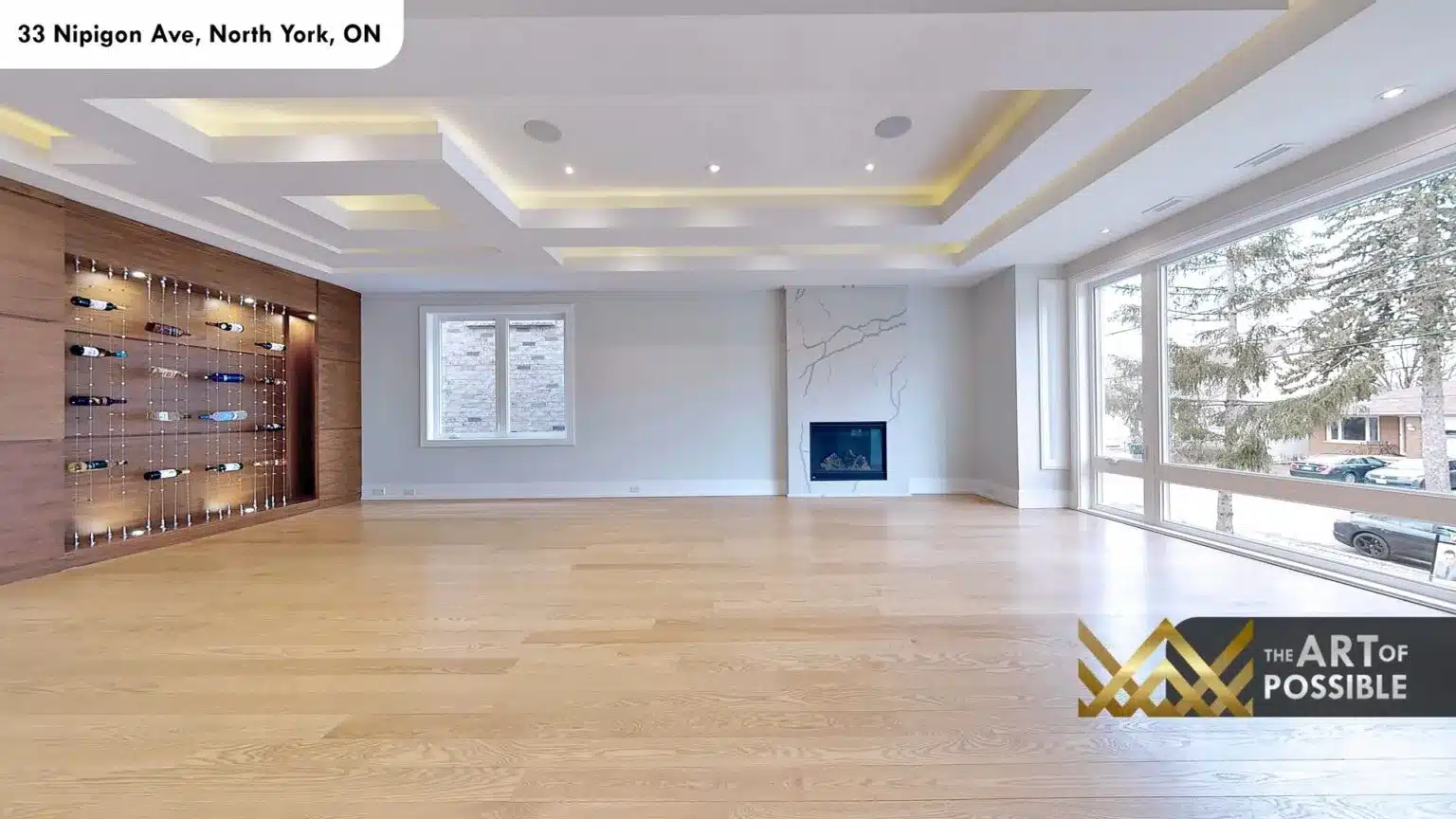 Full-width view of main floor living room showing wine wall and marble fireplace