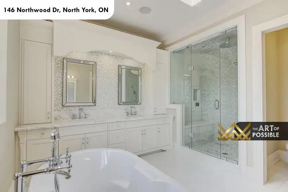 Glass-enclosed steam shower and double vanity in the primary ensuite
