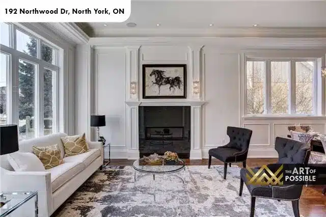 Living room fireplace wall with black marble surround and wall sconces